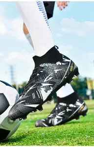 Detailed view of professional black high-top soccer cleats with studs on field