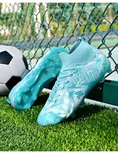 Detailed view of light blue high-top soccer cleats on a professional grass field.
