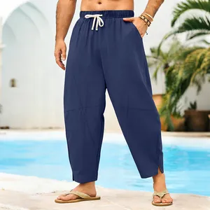 Full view of men's navy blue linen drawstring pants with a relaxed harem cut design.