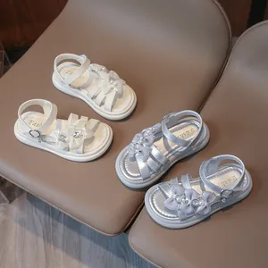 Elegant girls princess sandals featuring bow ties and pearls in white and silver colors