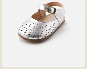 Détail macro de sandales argentées pour bébé fille avec motifs ajourés décoratifs