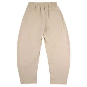 Rear view of men's loose linen harem pants with unique geometric stitching in beige