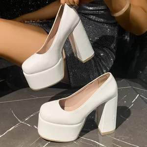 Side view detail of white patent leather platform heels with chunky block heel