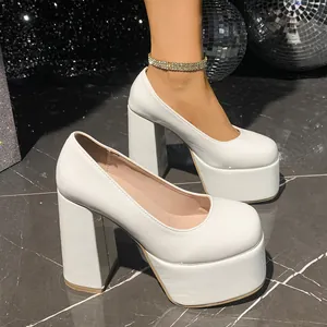 Close-up view of white patent leather platform chunky heels in a retro disco setting