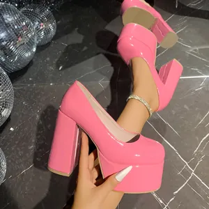 Close-up detail of glossy pink patent leather platform pumps featuring a square toe and chunky heel