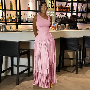 Elegant pink sleeveless evening dress with long fringe detail in a lounge setting