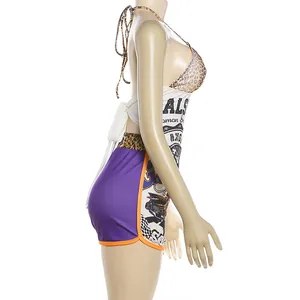Side profile of a trendy two-piece set featuring a halter top and graphic printed shorts