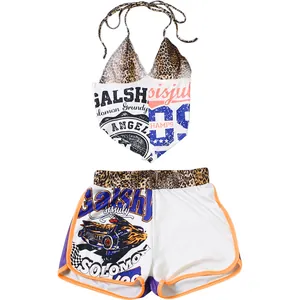 Detail view of women's halter top and shorts set with leopard and graphic prints.