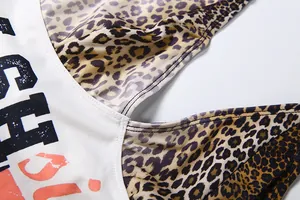 Detailed macro view of halter top showing leopard print and high-quality seam stitching.