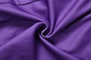 Close-up of vibrant purple fabric detail showing fine texture and soft finish for fashion tops
