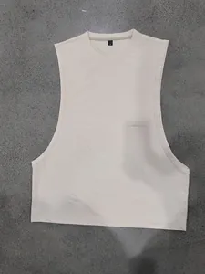 Overhead view of a beige men's loose gym muscle tank top for fitness and training