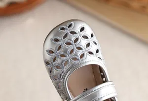 Vue détaillée d'une chaussure Mary Jane argentée pour fille avec motifs floraux ajourés