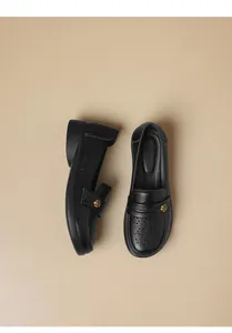 Detailed top-down view of black breathable mother shoes with gold floral accents