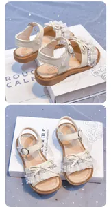 Detailed view of girls' elegant cream sandals featuring lace bows and soft anti-slip soles.