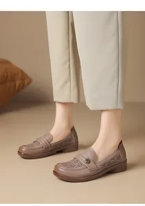 Detail view of taupe breathable hollow-out leather loafers with floral pattern for women