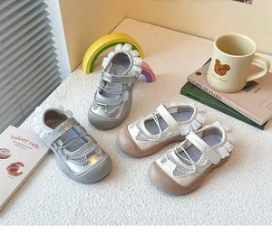 Detailed view of girls' ballet style sports mesh sandals in silver and cream colors