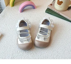 Close-up of girls ballet style sports sandals with lace trim and breathable mesh