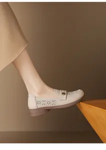 Detailed view of beige breathable leather loafers for women with soft soles and floral detail