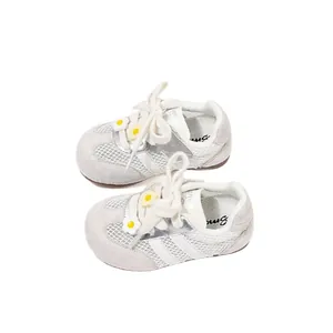 Breathable white mesh baby sneakers with a cute yellow flower decoration on laces