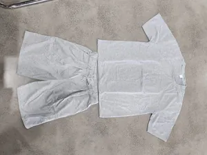 Vista detallada en plano de un conjunto de camiseta y pantalón corto casual gris para hombre.