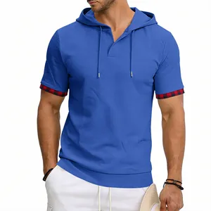 Detail view of blue men's hooded T-shirt with waffle texture and plaid cuffs.