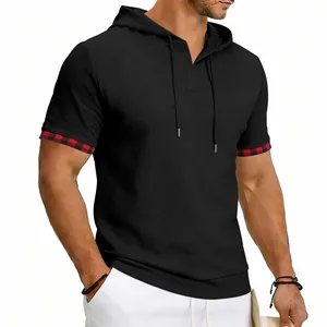 Close-up of men's black waffle textured hooded t-shirt featuring stylish plaid trim sleeves