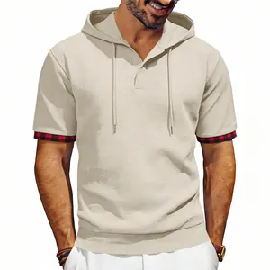 Detail showing the waffle knit texture and red plaid sleeve cuffs on a beige hoodie