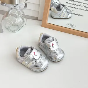 Detailed view of silver mesh infant shoes with breathable fabric and soft sole
