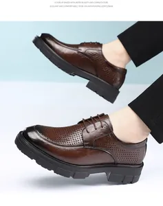 Close-up of brown leather derby shoes with breathable laser-cut perforations.