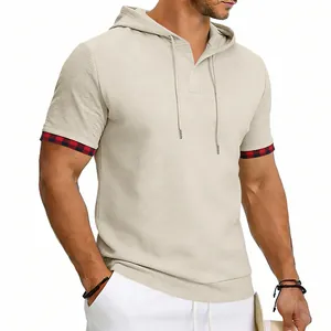 Detailed view of men's beige waffle knit hooded T-shirt with plaid cuff accents