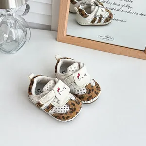 Detail of baby leopard print mesh walking shoes with cute cartoon cat strap closure.