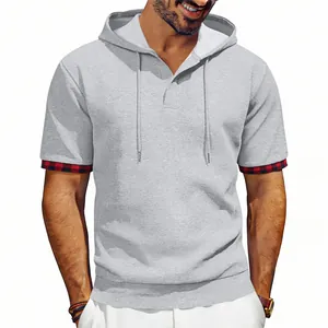 Detailed macro view of grey waffle knit hooded t-shirt with stylish plaid cuffs for men