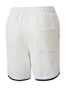 Detailed back view of men's white checkered sports shorts with back pocket and elastic waistband