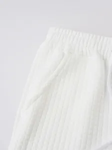 Close-up view of the white waffle texture fabric on men's casual sports shorts detail