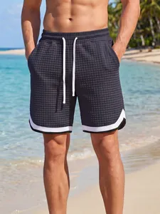 Close-up of men's waffle textured sports shorts with white drawstring for beach