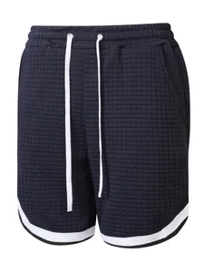 Close-up detail of navy blue men's grid texture athletic shorts with white drawstrings.