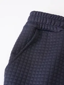 Detail view of navy blue waffle texture fabric on men's sports shorts waistband.