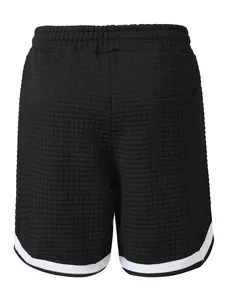 Detailed view of men's black waffle knit shorts showing unique grid texture and white trim