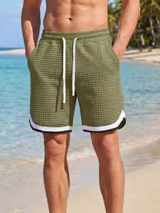 Detail of olive green waffle textured men's sport shorts in beach vacation style.