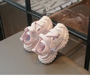 Primer plano de sandalias infantiles de malla rosa transpirable con suelas blandas.