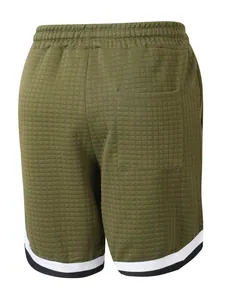 Close-up back view of army green waffle knit shorts featuring striped hem and pocket detail