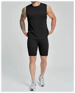 Professional full view of men's black sleeveless athletic top and tight fitness shorts set