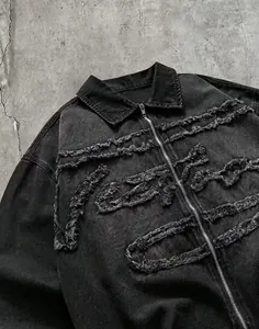 Gros plan d'une chemise en jean avec des motifs effilochés et une fermeture éclair