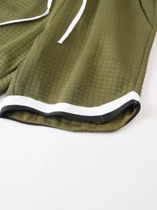 Macro view of olive green waffle texture fabric and contrast cuff of men's sports shorts