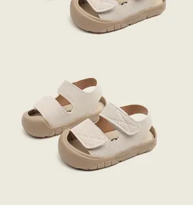 Detail of beige baby sandals with soft rubber sole and dual hook-and-loop straps