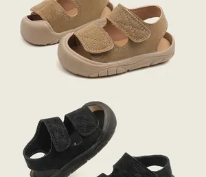 Detailed view of infant toddler walking sandals in tan and black with soft soles
