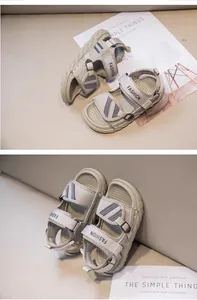 Detailed close-up view of beige breathable mesh boy's summer sandals with FASHION strap