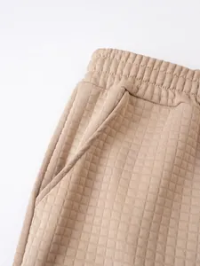 Detail shot of men's casual sports shorts with khaki square waffle texture and pocket