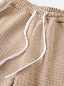 Close-up of beige checkered waffle texture on men's casual sports shorts