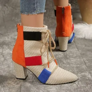 Detailed view of color-block patchwork ankle boots with chunky heel and gold laces